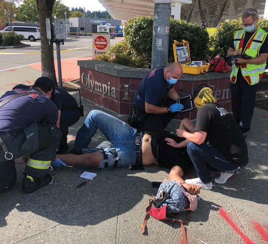 This shows Olympia police rendering aid to Tusitala Toese, who was hit by one of five bullets allegedly fired by Benjamin Anthony Varela on Sept. 4, 2021.